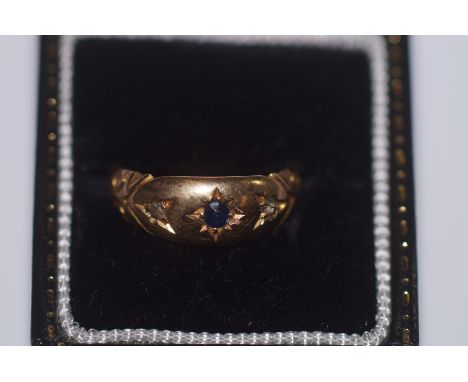 18ct Gold ring set with blue sapphire flanked by 2 diamonds Size L