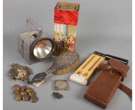 A quantity of collectables. Includes military buttons, silver mounted hand mirror, silver ARP badge, Bardic Ltd railway lamp,