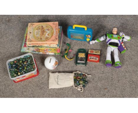 A quantity of children's collectables and toys to include Buzz Lightyear figure, large quantity of marbles, Rupert Annuals, e