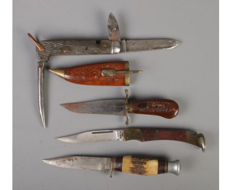 Four knives. Includes large John Mcclory folding knife, Eastern dagger, small hunting knife and one other folding knife. CAN 