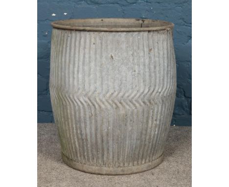 A galvanised metal dolly tub. 53cm high.  Holes to the bottom; has been used as a planter.