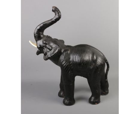 A papier mache Liberty of London style figure of an elephant. Approx. 52cm tall.&nbsp;Hole to back, signs of repair to one si