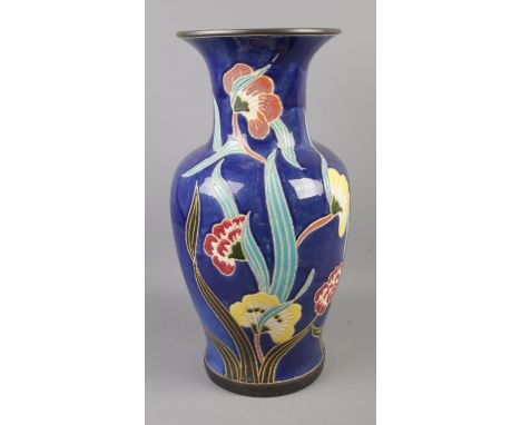 A painted ceramic floor vase featuring floral decoration. Approx. 52cm tall.  