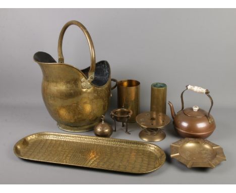 A collection of brass and copper items. Includes coal scuttle, kettle, artillery shells, crocodile skin effect tray etc.  