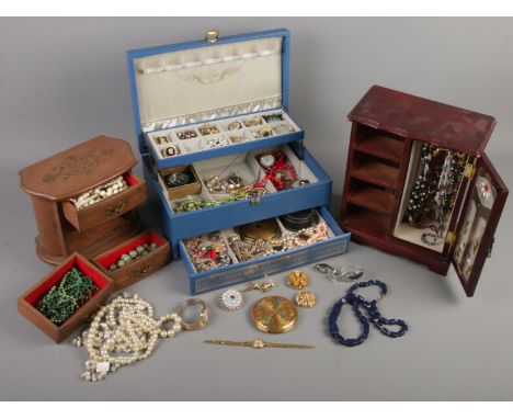 Three jewellery boxes with contents of costume jewellery. Includes brooches, beads, necklaces, ladies manual Oris wristwatch,