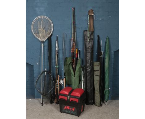 A large quantity of fishing equipment. Includes rods, nets, umbrella, tackle box, Daiwa fishing rod, etc.  