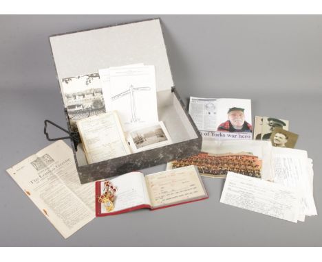 A box of ephemera and badges. Includes military information relating to Major Kenneth Higton, Royal Army Ordnance Corps badge