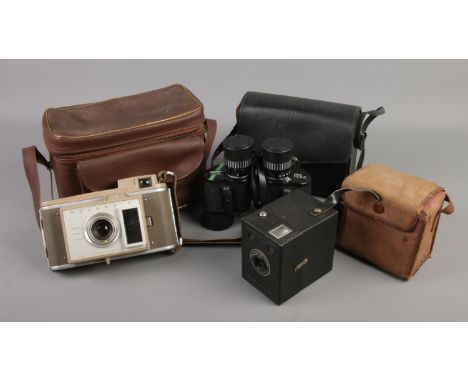 Two cameras and a pair of binoculars. Includes Polaroid J33 Land Camera, Kodak Six20 brownie camera and pair of cased Chinon 