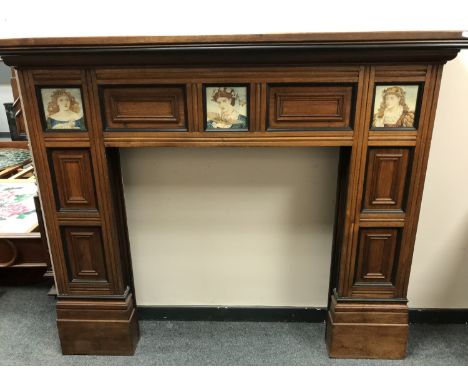 A late Victorian oak fire surround inset with ceramic panels by Cottier &amp; Co., width 167 cm. CONDITION REPORT: Ceramic ti