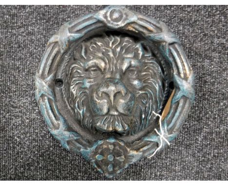 A cast iron lion head door knocker 