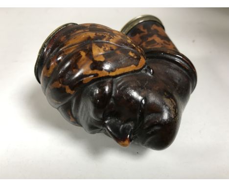 A pipe bowl modelled as an Indian man wearing a turban, with mottled faux tortoiseshell decoration