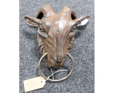 A cast iron goat head with ring 