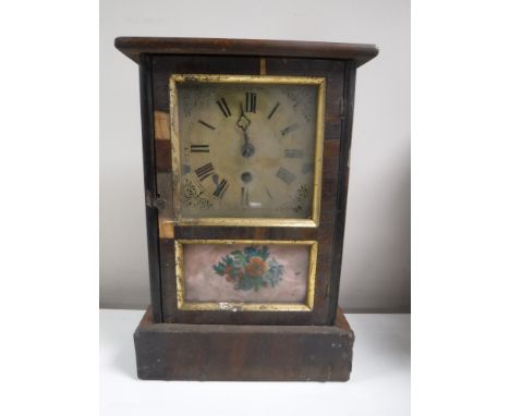 An antique pine cased American mantel clock