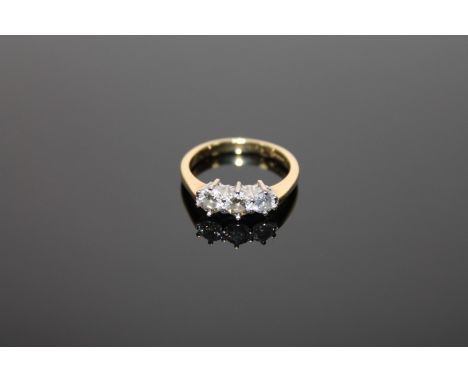 An 18ct gold three stone diamond ring, size M