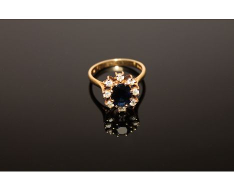 An 18ct gold sapphire and diamond cluster ring
