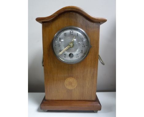 An inlaid mahogany cased Junghans mantel clock with pendulum and key 