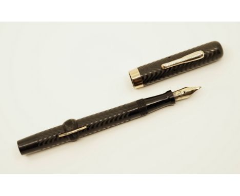 Conklin Crescent Filler 40 model fountain pen in black chased hard rubber. The pen has sharp chasing and good trim with light