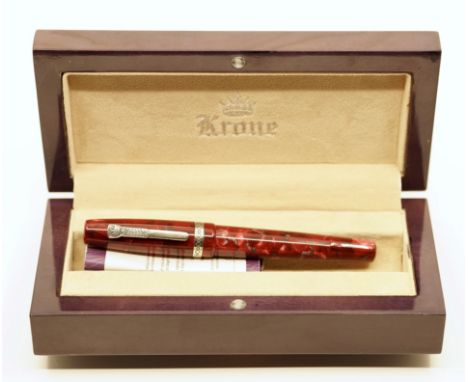 Krone Red Boulder fountain pen, boxed. It has red hues with grey veining, silver trim and a fine 18k Krone nib with piston fi