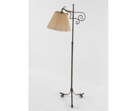 An adjustable lamp on wrought iron stand with tripod base