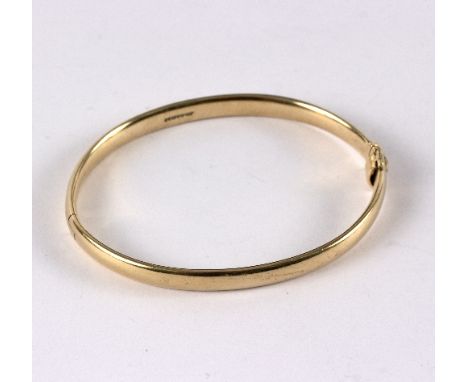 A 9ct gold hinged bangle, of plain form, approximately 23.9gm