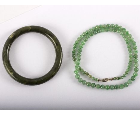 A jade single-row beaded necklace and a nephrite bangle