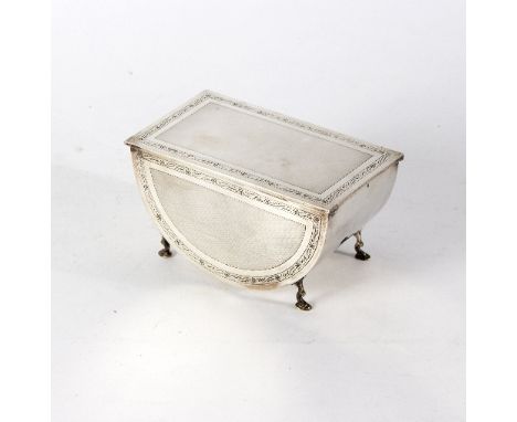 An Art Deco silver casket, Birmingham 1929, of half round form with rectangular hinged cover, engine-turned decoration of fou