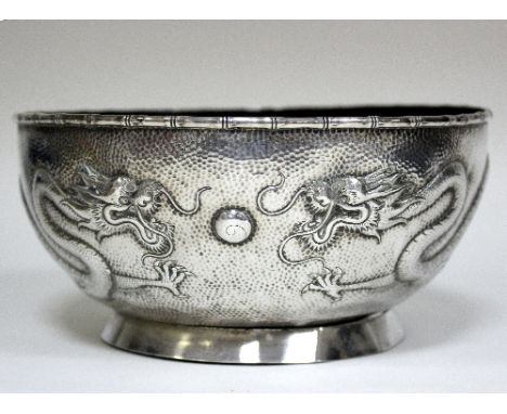 A Chinese export silver bowl, circular with bamboo rim and dragon pursuing a flaming pearl to the sides, character mark benea