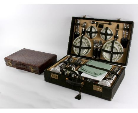 A large picnic hamper, fitted with vacuum flasks, porcelain plates and cups, storage containers, flatware, etc., the case 63c