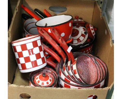 A quantity of red and white enamel kitchenware including graduated sets of pans and jars