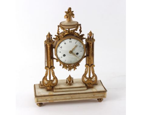 A French gilt metal mounted mantel clock, the white enamel dial with Arabic numerals to a rectangular plinth, 31cm wide and a