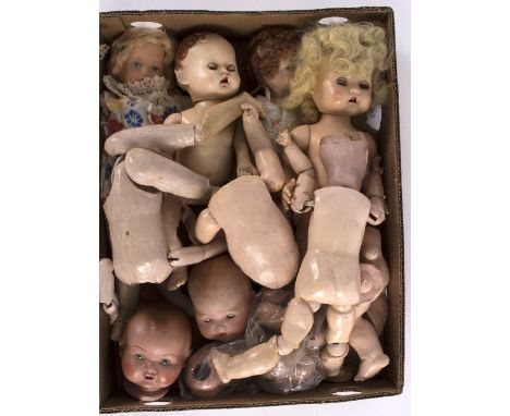 A quantity of various dolls and body components to include a Chad Valley stuffed doll, another similar and an Armand Marseill