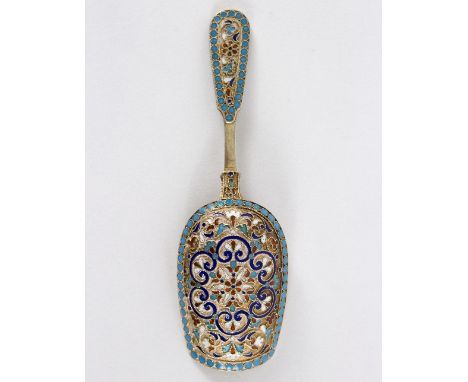 A late 19th Century Russian silver gilt and enamel caddy spoon, the reverse of the bowl and the terminal with coloured enamel
