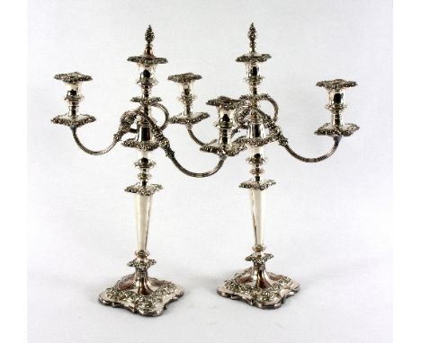 A pair of Sheffield plated two-branch, three-light candelabra, the branches of reeded scrolling form, 51.5cm high