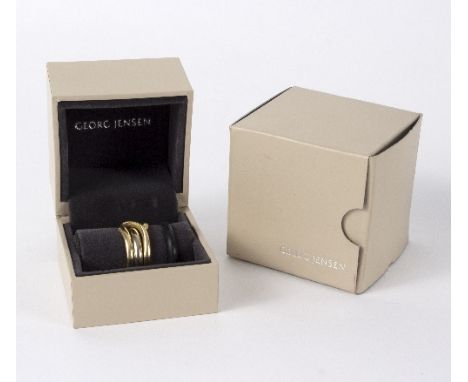 A Georg Jensen 18ct yellow and white gold 'magic ring', designed by Regitze Overgaard, the outer ring yellow gold numbered 13