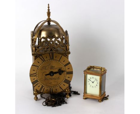 A reproduction lantern clock, the dial signed Tho' Moore, Ipswich, 36.5cm high and a gilt brass cased carriage clock, 15cm hi