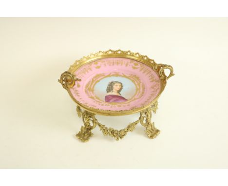 A very fine French gilt brass Sevres style porcelain Table Centre, c. 1900, the pink porcelain dish centre with portrait of a