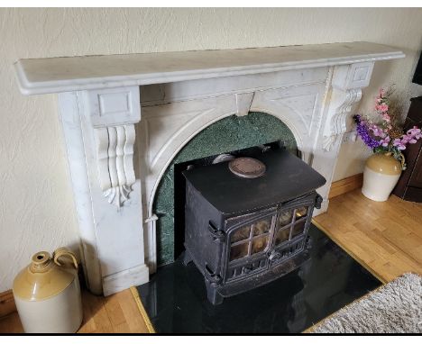 A Victorian Carrera&nbsp;marble Fire Surround,&nbsp;the plain shelf with moulded edge, over an arched centre, flanked by bloc