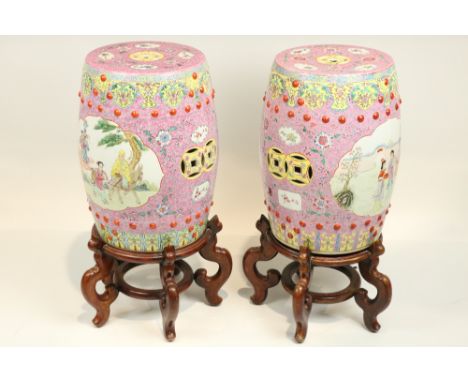 A pair of attractive Chinese Famille Rose barrel shaped Garden Seats, each with pierced top with all-over pink floral design,