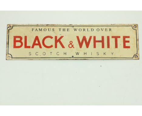 A Vintage style enamel Advertisement Sign, 'Black and White Scotch Whiskey - Famous The World Over,' approx. 13cms x 46cms (5