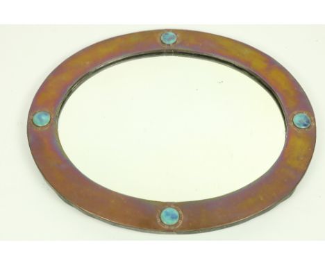 An Art Nouveau period brass oval Mirror, with decorative blue enamel inlay, approx. 64cms x 52cms (25" x 20 1/2"). (1) 