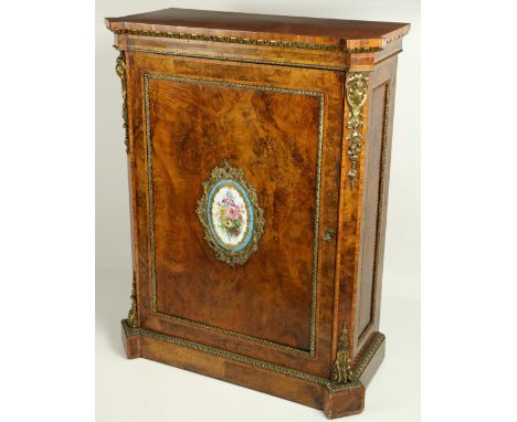 An attractive 19th Century walnut Side Cabinet, the shaped top with egg n' dart moulding, decorative ormolu sabots and beadin