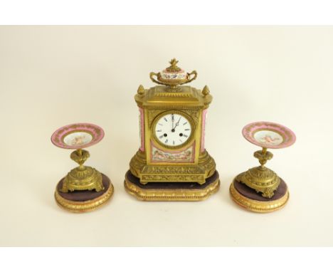 A 19th Century French gilt brass and porcelain Mantle Clock Garniture, the clock case with an oviform porcelain two handled u