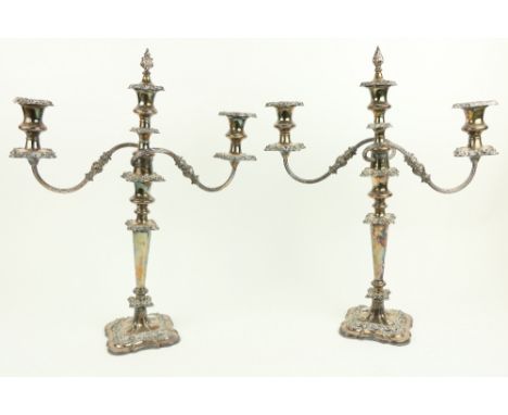 A pair of two branch three light Sheffield silver plated Candelabra, each with leaf cast scroll arms and urn shaped sockets, 