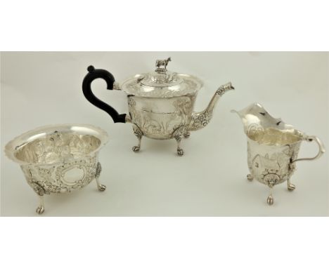 A three piece Irish silver Tea Service, Dublin 1976, comprising: teapot with cow finial, the body chased with milk maid, cow 