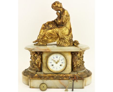 After J. Pradier  A French onyx and brass Mantle Clock, surmounted with a seated classical woman, above a circular dial,&nbsp