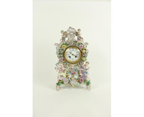 A German porcelain Mantle Clock, c. 1900, with Lenzkirch movement, the case crested with two cherubs holding garlands of flow