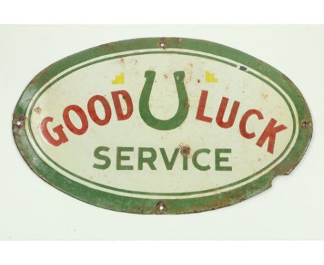A rare Vintage style enamel Sign, 'Good Luck Service,' of oval form, approx. 31cms x 51cms (12" x 20"), pierced and worn, as 