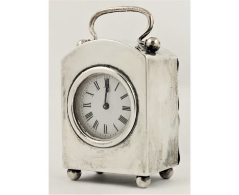 An arch top silver cased Carriage Clock, London 1927, with French movement, the swing handle above a circular enamel dial wit