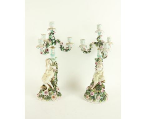 A pair of Sitzendorf flower encrusted porcelain Candelabra, c. 1900, each with three floral arms and a centre light, on a fig