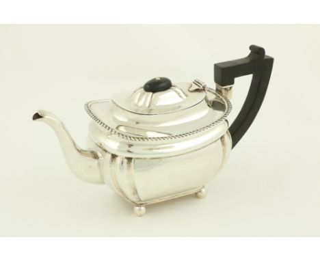 A silver rectangular ogee shaped Teapot, Birmingham 1929, with bead edge and raised on four ball feet, 27cms (10 3/4") 610g. 